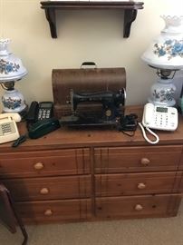 Phones and sewing items on solid wood dresser!