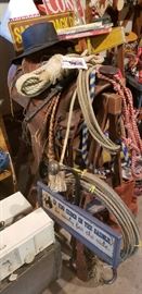 Vintage leather saddle, hat, lariats, bull rider's rope never used, whips, etc.