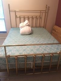 Brass Bed with mattress and box spring.  I believe it is a full but we can measure it