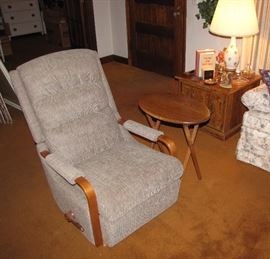 A recliner chair, oval folding table, and the matching side table towards the back right.
