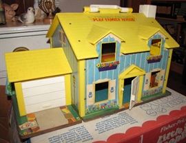 This is a vintage Fisher-Price Play Family House.  The garage door rolls up, and the front door opens.  