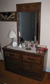 A six drawer mirrored dresser.  It might match the nightstands, but even if they don't, they still look good together.