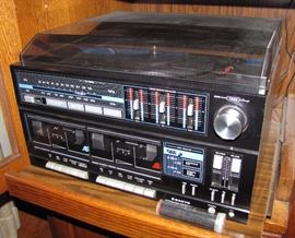 This is a vintage dual tape desk, stereo receiver, and turntable unit.  The tube contains the LP dust remover.  