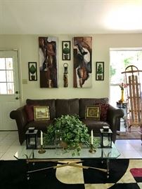 Faux Leather couch, Glass & Plated Coffee Table, Faux ivy, Lanterns Candle Holders, Artwork