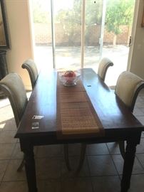 Long farm atable with four upholstered chairs. Chairs are priced separate