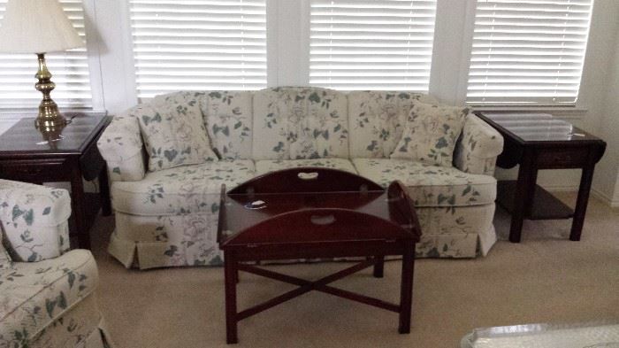 Matching cloth sofa and love seat.  Matching mahogany coffee table and 2 end table.  Brass table lamp. 