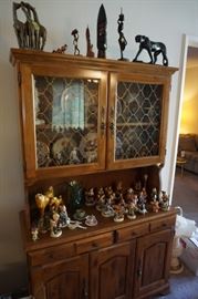 Maple hutch cabinet loaded with statues, soapstone, African art etc