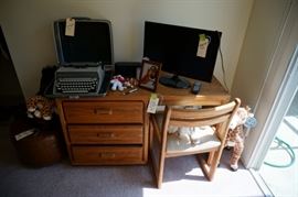 Two flat screen TVs and two old Remington typewriters in case