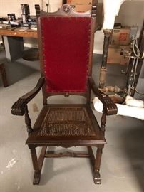 antique Jacobean Revival style high backed armchair, carved wood frame, red upholstered back, caned seat, 