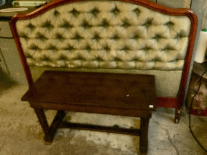 green upholstered and tufted double sized headboard, piano bench in front