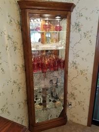 A beautiful Howard Miller Corner Curio Cabinet.