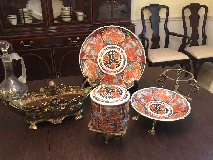 Brass trivets, Andrea Sadek porcelain plates and bowls