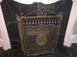 several fire screens and fireplace tools