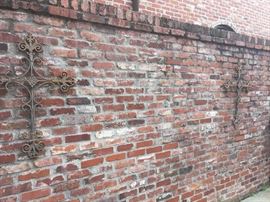 several iron decorative crosses and other yard art