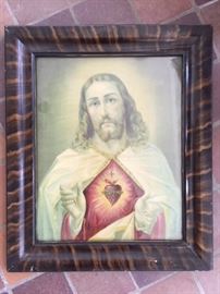 Large framed print of Jesus emblazoned with a flaming sacred heart. Frame is scratched but can possibly be restored.