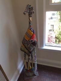 Giraffe made by the Ndebele peoples of South Africa. Beadwork, cloth and metal over wood. Late 20th century.