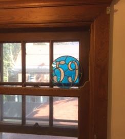 Small stained glass hanging with number "59." 