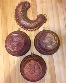 Heavy, round antique copper molds with rooster, fish and crab motifs. With a vintage copper mold in the shape of a fish.