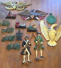 Painted metal wall plaques depicting trains, eagles and colonial militia men, from our vintage Americana department in the third floor ballroom.