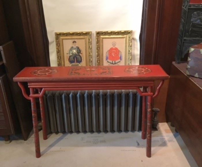 Two Chinese goache-on-silk ancestor paintings in gilt wood frame, behind a Chinese cinnaboar-colored laquered wood table. In our first floor dining room. 