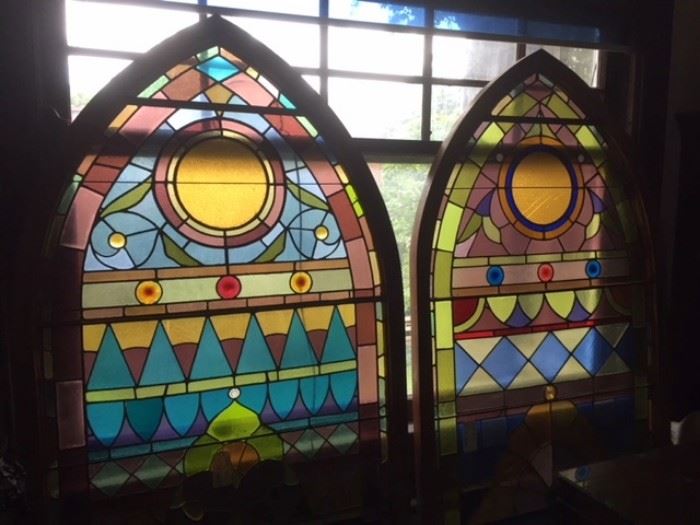 Antique stained glass church windows standing in the first floor library.