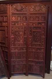 Ornate, carved wood 4-panel screen of uncertain date, origin and iconography. Possibly Moorish? In any case, magnificent. In the dining room. 
