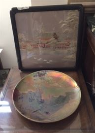 In the living room: a framed Chinese landscape embroidery behind an Art Nouveau-era ceramic charger with landscape imagery created by celebrated French artist Clement Massier (1845-1917).  See next image for back of plate and more information on Massier.