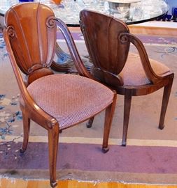 two of four carved dining chairs