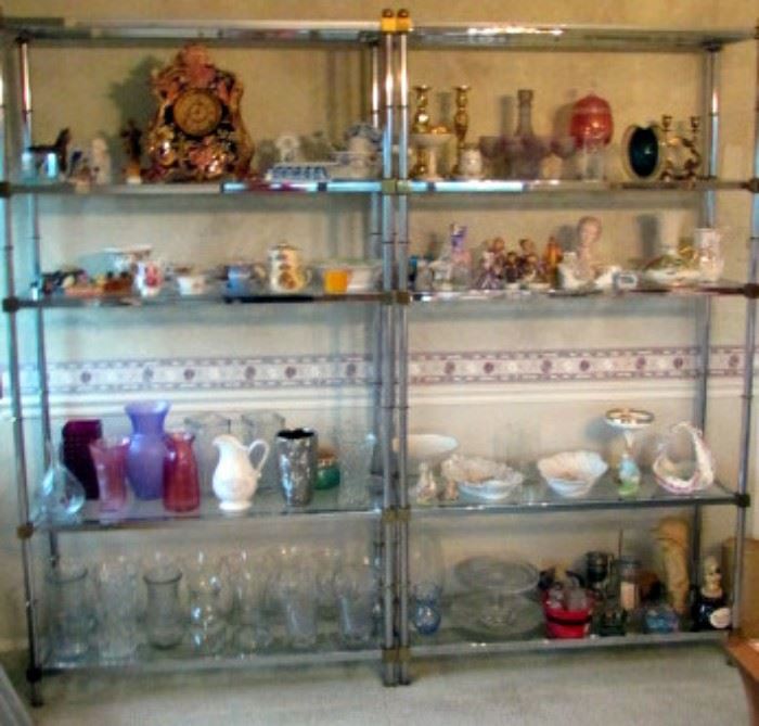 Brass and glass display shelving packed with decorative items