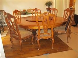 Huge round Oak table and 9 chairs and pads for table as well 