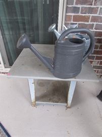 Grilling table, metal and palstic watering cans