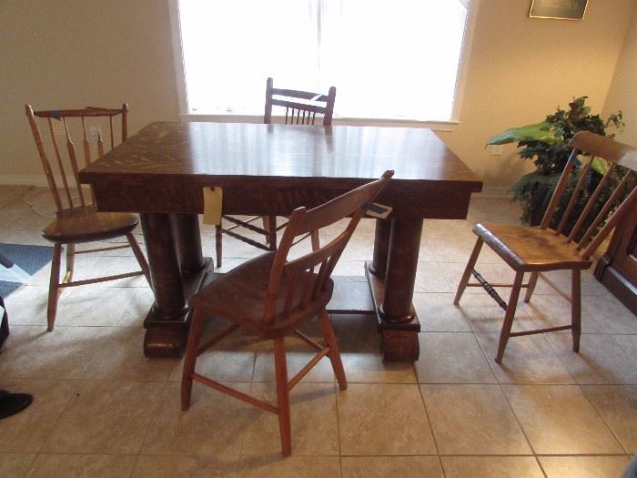 Tiger oak or 1/4 sawn Oak library table with drawer and column decor.  Four miscellaneous wooden vintage chairs