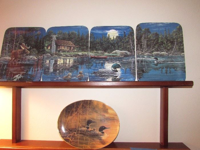 Four collectible loon plates and one collectible oval loon plate with wooden rack included