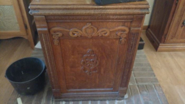 Antique sewing machine cabinet without the machine.  The top folds out for workspace.