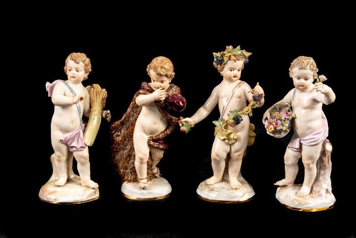 GROUP OF FOUR ANTIQUE MEISSEN PUTTO FIGURES- ICE SKATING, HOLDING FLOWERS, AND A WHEAT SHEAF Item #: 90443