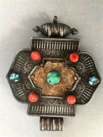 Tibetan gau , with coral and turquoise and gold sheet on top of silver. 