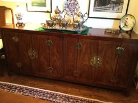 Asian flare Henredon buffet w/brass intricate hardware. 70" L  x 19" x   31" H  Four doors fold open to reveal drawer and shelf