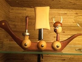 Wooden Viking ship holding bar utensils