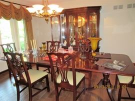 Overview of Thomasville dining suite showcasing chairs, table and lighted display cabinet