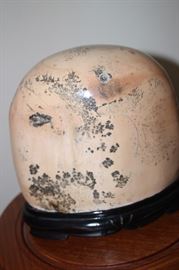 Large polished stone with Asian decor.