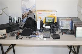 Phone set, digital photo frame, Bose Wave radio. CDs, DVDs, cameras. Slim Line external hard drive.