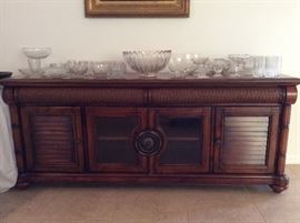 Cindy Crawford Key West Living Room Console shown with a collection of crystal pieces...