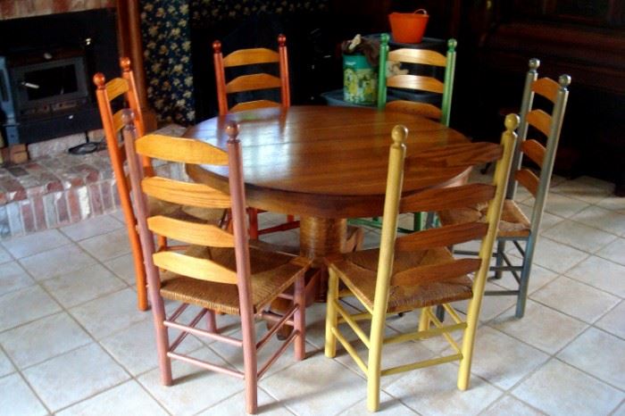 Antique round oak pedestal table and six vintage ladder back chairs, 