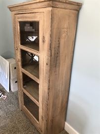 Distressed wood cabinet with glass fronts