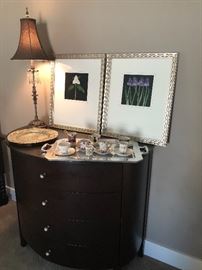 Dresser with buffet lamp, pewter tray with a collection of porcelain china tea cups and brushed gold/silver framed prints