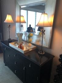 Sideboard/sidebar with buffet lamps and large mirror, also mirrored bottom tray, large glass and metal container, blown glass vase and bar/shaker set
