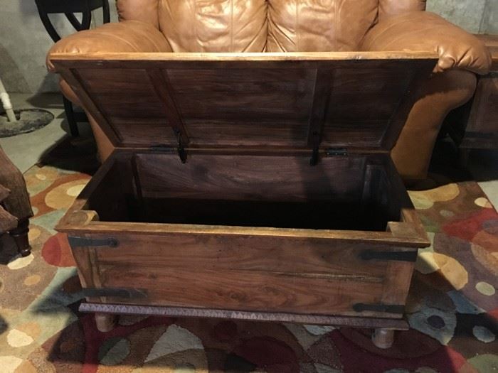 Rustic wooden trunk/coffee table with storage and wrought iron hardware.