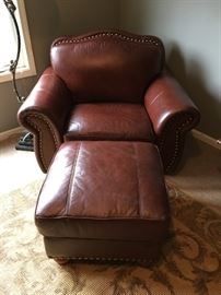 Pleather oversized club chair and ottoman with nail head trim.