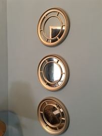 Three small framed mirrors.