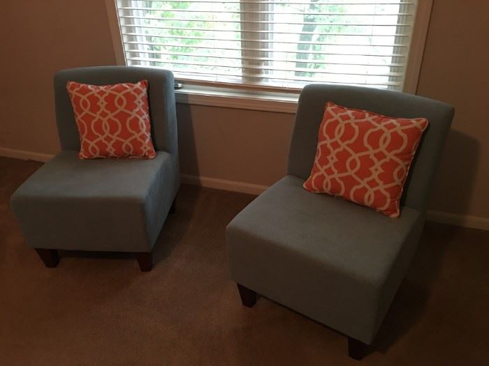 Two very cute light blue upholstered chairs.